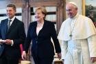 Pope Francis smiles with German Chancellor Angela Merkel and her husband Joachim Sauer, left, on the occasion of their private audience, at the Vatican, Saturday, June 17, 2017. (Ettore Ferrari/Pool Photo via AP)