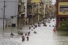 People move through flooded streets in Havana after the passage of Hurricane Irma, in Cuba, Sunday, Sept. 10, 2017. (AP Photo/Ramon Espinosa)