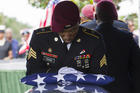 Sgt. Donald Young places a U.S. flag over the casket of Sgt. La David Johnson during his burial service in Hollywood, Fla., on Saturday, Oct. 21, 2017. Mourners remembered not only a U.S. soldier whose combat death in Africa led to a political fight between President Donald Trump and a Florida congresswoman but his three comrades who died with him. (Matias J. Ocner/Miami Herald via AP)
