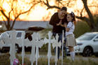 Meredith Cooper, of San Antonio, Tex., and her 8-year-old daughter, Heather, visit a memorial of 26 metal crosses near First Baptist Church in Sutherland Springs, Tex., on Nov. 6. (Jay Janner/Austin American-Statesman via AP)
