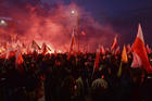 Demonstrators burn flares and wave Polish flags during the annual march to commemorate Poland's National Independence Day in Warsaw, Poland, Saturday, Nov. 11, 2017. Thousands of nationalists marched in Warsaw on Poland’s Independence Day holiday, taking part in an event that was organized by far-right groups. (AP Photo/Czarek Sokolowski)