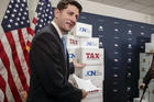 Speaker of the House Paul Ryan, R-Wis., points to boxes of petitions supporting the Republican tax reform bill that is set for a vote later this week as he arrives for a news conference on Capitol Hill in Washington, Tuesday, Nov. 14, 2017. (AP Photo/J. Scott Applewhite)
