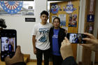 U.S. citizen Benjamin Zepeda, 14, with his mother Lorena Zepeda, who benefits from Temporary Protected Status, have their photo taken after a news conference in Los Angeles on Jan. 8. (AP Photo/Damian Dovarganes)