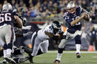 In this Dec. 6, 2015 photo, New England Patriots quarterback Tom Brady (12) scrambles away from Philadelphia Eagles defensive end Fletcher Cox (91) during a game in Foxborough, Mass. (AP Photo/Steven Senne, File).