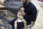 A medical worker gives a child oxygen following an alleged poison gas attack in the opposition-held town of Douma, near Damascus, Syria, on April 8. (Syrian Civil Defense White Helmets via AP)