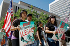 In this June 15, 2010, file photo, immigration reform advocates march around the Federal Courthouse in downtown Denver. (AP Photo/David Zalubowski, File)