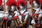 In this May 6, 2008 file photo, new Vatican Swiss Guards adjust their helmets prior to a swearing-in ceremony at the Vatican. The world’s oldest standing army is getting some new headgear. The Swiss Guards plan to replace their metal helmets with plastic PVC ones made with a 3-D printer, giving the pope's army cooler and more comfortable headgear when standing guard for hours at a time. (AP Photo/Alessandra Tarantino, pool)