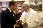 Pope Francis and with French President Emmanuel Macron, left, exchange gifts on the occasion of their private audience, at the Vatican, Tuesday, June 26, 2018. (Alessandra Tarantino/Pool Photo via AP)