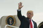 President Donald Trump waves as he boards Air Force One at Morristown Municipal Airport, in Morristown, N.J., Sunday, July 22, 2018, en route to Washington after staying at Trump National Golf Club in Bedminster, N.J. (AP Photo/Carolyn Kaster)
