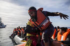 A woman is rescued by aid workers of Spanish NGO Proactiva Open Arms in the Central Mediterranean Sea on Dec. 21, 2018. (AP Photo/Olmo Calvo)