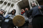 Native American protestors hold hands with parishioner Nathanial Hall, right, during a group prayer outside the Catholic Diocese of Covington on Jan. 22, 2019, in Covington, Ky. (AP Photo/John Minchillo)