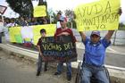 Demonstrators hold signs in support of the country's self-proclaimed president Juan Guaido and and for foreign humanitarian aid, next to the Tienditas International Bridge, near Cucuta, Colombia, on Feb. 8. (AP Photo/Fernando Vergara)