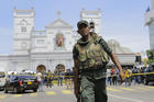 Sri Lankan Army soldiers secure the area around St. Anthony's Shrine after a blast in Colombo, Sri Lanka, Sunday, April 21, 2019. Witnesses are reporting two explosions have hit two churches in Sri Lanka on Easter Sunday, causing casualties among worshippers. (AP Photo/Eranga Jayawardena)