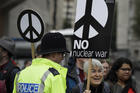 Anti war demonstrators hold banners as they protest outside Westminster Abbey, as a service to recognize 50 years of continuous deterrent at sea takes place in London on May 3. (AP Photo/Kirsty Wigglesworth)