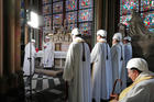 The Archbishop of Paris Michel Aupetit, second left, leads the first mass in a side chapel, two months after a devastating fire engulfed the Notre-Dame de Paris cathedral
