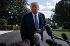 President Donald Trump talks to reporters on the South Lawn of the White House, on Friday, Oct. 4, in Washington. (AP Photo/Evan Vucci)