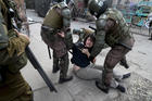 Police detain a demonstrator during an anti-government protest in Santiago, Tuesday, Nov. 5, 2019. Chileans have been taking to the streets and clashing with the police to demand better social services and an end to economic inequality, even as the government announced that weeks of demonstrations are hurting the country's economic growth. (AP Photo/Esteban Felix)
