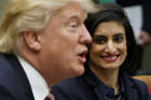 In this March 22, 2017 file photo, Administrator of the Centers for Medicare and Medicaid Services Seema Verma listen at right as President Donald Trump speaks during a meeting in the Roosevelt Room of the White House in Washington. The Trump administration has a Medicaid deal for states: more control over health care spending on certain low-income residents if they agree to a limit on how much the feds kick in. (AP Photo/Evan Vucci, File)