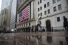 A pedestrian walks past the New York Stock Exchange on March 19. (AP Photo/Kevin Hagen)
