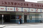 Should the U.S. reopen all at once or one screen at a time? A woman walks past the closed Lakeshore Cinema in Euclid, Ohio, on May 6. (AP Photo/Tony Dejak)