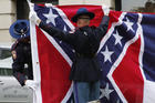 A Mississippi Highway Safety Patrol honor guard folds the retired Mississippi state flag after it was raised over the Capitol grounds one final time in Jackson, Miss., on July 1. (AP Photo/Rogelio V. Solis)