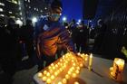 Health service workers light candles during a vigil for coronavirus victims at Elmhurst Hospital in Queens, New York, on April 16. (Photo by John Nacion/STAR MAX/IPx 2020)