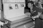 In this 1955 file photo, Mamie Bradley, mother of Emmett Till, pauses at her son's casket at a Chicago funeral home. 