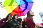 Saffron Edwards, 15, holds up a rainbow-colored umbrella during a student walkout at Dowling Catholic High School in Des Moines, Iowa. Students, alumni and supporters were protesting the school’s decision not to hire a gay teacher in April 2015. (AP Photo/The Des Moines Register, Michael Zamora)
