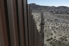 This Jan. 25, 2017, file photo shows a truck driving near the Mexico-US border fence, on the Mexican side, separating the towns of Anapra, Mexico and Sunland Park, New Mexico.  (AP Photo/Christian Torres, File)