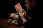 In this Monday, May 20, 2013 file photo, Sotheby's director of the department of printed books and manuscripts Dr Philip Errington poses for photographers by holding a first edition copy of the first Harry Potter book "Harry Potter and the Philosopher's Stone" containing annotations and illustrations by author J.K. Rowling on top of a stack of other annotated first edition books featuring at auction, at the auction house's premises in London. (AP Photo/Matt Dunham, File)