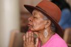 An elderly woman prays during Mass Nov. 13 at St. Peter Claver Church in Baltimore (CNS photo/Bob Roller). 