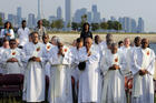 With the Chicago skyline in the background, deacons pray as participants gather to end violence and promote peace during the eighth annual Sunrise Prayer Service and Mass on Aug. 26, 2017. (CNS photo/Karen Callaway, Chicago Catholic)