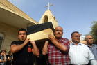 Iraqi men carry the coffin of a Christian man, who was killed by unknown gunmen, during his funeral in 2011 in Kirkuk (CNS photo/Khalil Al-A'nei, EPA).