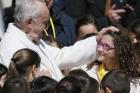  04.19.2017 Pope Francis greets a young choir member during his general audience in St. Peter's Square at the Vatican April 19. (CNS photo/Paul Haring)