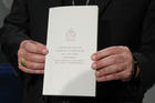 Archbishop Angelo De Donatis, papal vicar for the Diocese of Rome, holds a copy of Pope Francis' exhortation, "Gaudete et Exsultate" ("Rejoice and Be Glad"), during a news conference on the exhortation at the Vatican April 9. (CNS photo/Paul Haring)