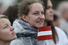  A young woman holds the Latvian flag as Pope Francis celebrates Mass Sept. 24 at the Shrine of the Mother of God in Aglona, Latvia. (CNS photo/Paul Haring) 