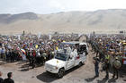 Pope Francis greets the crowd before celebrating Mass at Lobito beach in Iquique, Chile, Jan. 18. (CNS photo/Paul Haring)