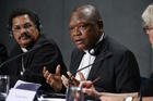  Cardinal Fridolin Ambongo Besungu of Kinshasa, Congo, speaks at a news conference after a session of the Synod of Bishops for the Amazon at the Vatican Oct. 22, 2019. At left is Bishop Karel Choennie of Paramaribo, Suriname. (CNS photo/Paul Haring) 