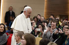 Pope Francis prepares to take a photo with young people at a presynod gathering of youth delegates in Rome March 19. (CNS photo/Paul Haring)