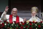 Pope Francis and Ecumenical Patriarch Bartholomew of Constantinople greet a small crowd after delivering a blessing in 2014 in Istanbul (CNS photo/Paul Haring).