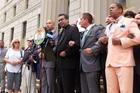 Local elected officials and religious leaders join arms in prayer, led by Catholic Charities Bronx Regional Director Father Eric Cruz, on the steps of the Bronx County Building in New York City on June 22.  (Photo: Allyson Escobar)