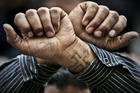 In this Friday, April 14, 2006 file photo, Egyptian Copts cross their wrists in defiance outside the Saints Church in the Sidi Bishr district of Alexandria in Egypt. Egypt’s Coptic Christians have become the preferred target of Islamic State radicals operating in the Arab world’s most populous nation, seeking to sow discord, undermine President Abdel-Fattah el-Sissi, and split the country. (AP Photo/Ben Curtis, File)