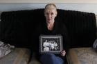 Helen McKendry holds a family photo with her mother, Jean McConville, at home in Killyleagh, Northern Ireland, in 2012 (AP Photo/Peter Morrison).