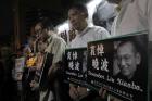 Protesters mourn jailed Chinese Nobel Peace laureate Liu Xiaobo during a demonstration outside the Chinese liaison office in Hong Kong on July 13. Officials say China's most prominent political prisoner, Nobel Peace Prize laureate Liu Xiaobo, has died. He was 61. (AP Photo/Vincent Yu)