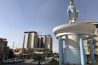 “Mother Mary” gazes serenely down on the traffic fuming and stalling around her in Ankawa, a suburb of Erbil. (Kevin Clarke)