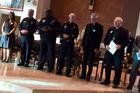 Dallas Auxiliary Bishop Gregory Kelly (left) and Bishop Edward J. Burns (right) meet with local law enforcment during a Dallas Area Interfaith meeting last November. Photo courtesy Dallas Area Interfaith