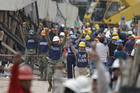 Soldiers hold up closed fists motioning for silence during rescue efforts at the Enrique Rebsamen school in Mexico City, Mexico, on Sept. 21. (AP Photo/Rebecca Blackwell)