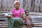 Rosmaida Bibi, right, who suffers from severe malnutrition, sits with her 20-year old mother Hamida Begum outside their makeshift shelter at the Dar Paing camp, north of Sittwe, Rakhine State, Myanmar, in March 2017. Rosmaida Bibi looks a lot like any of the underfed 1-year-olds in a squalid camp for Myanmar's displaced ethnic Rohingya minority—but she's 4. She cannot grow, and her mother can't find anyone to help her because authorities won't let Rohingya leave the camp. (AP Video)