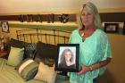 Patty Farrell stands beside a memorial to her daughter in front of her home on Friday, June 16, 2017 in Colonie, N.Y.. Farrell found her daughter, Laree, dead of a heroin overdose in bed four years ago and is now lobbying for a state law setting harsher penalties for drug dealers whose product causes a death. (AP Photo/Mary Esch)