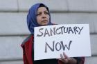 In this Jan. 25, 2017 file photo, Moina Shaiq holds a sign at a rally outside of City Hall in San Francisco. (AP Photo/Jeff Chiu, File)